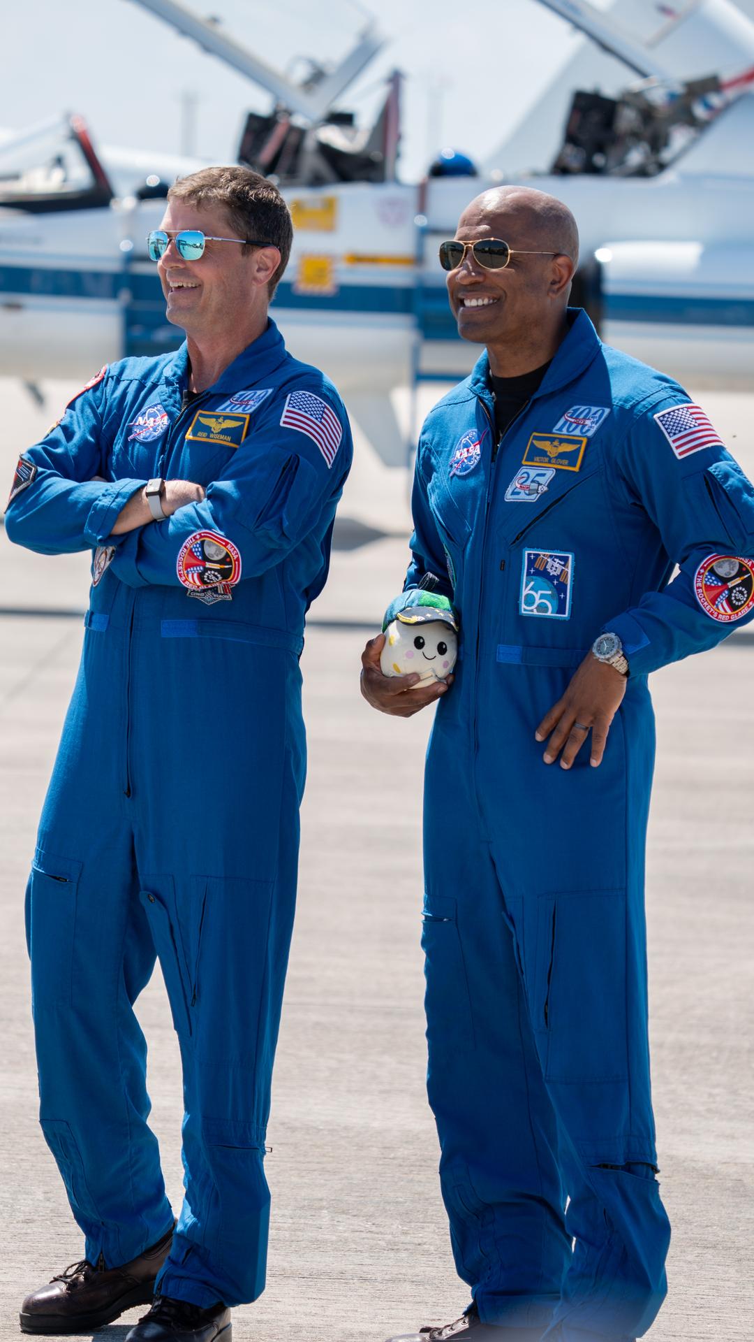 These images show the moments shortly after the arrival of the Artemis II crew to NASA’s Kennedy Space Center on March 27, 2026 ahead of the launch. The four astronauts, Victor Glover, Reid Wiseman, Christina Koch, and Jeremy Hansen, arrived on a T38, which can be seen behind them. They took turns speaking to the crowd as they also announced the zero-gravity indicator they would be taking with them on their journey.   
